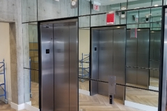 Mirror wrapped around elevator